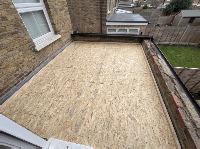 The same flat roof with a new deck of fresh boards screwed down over the joists