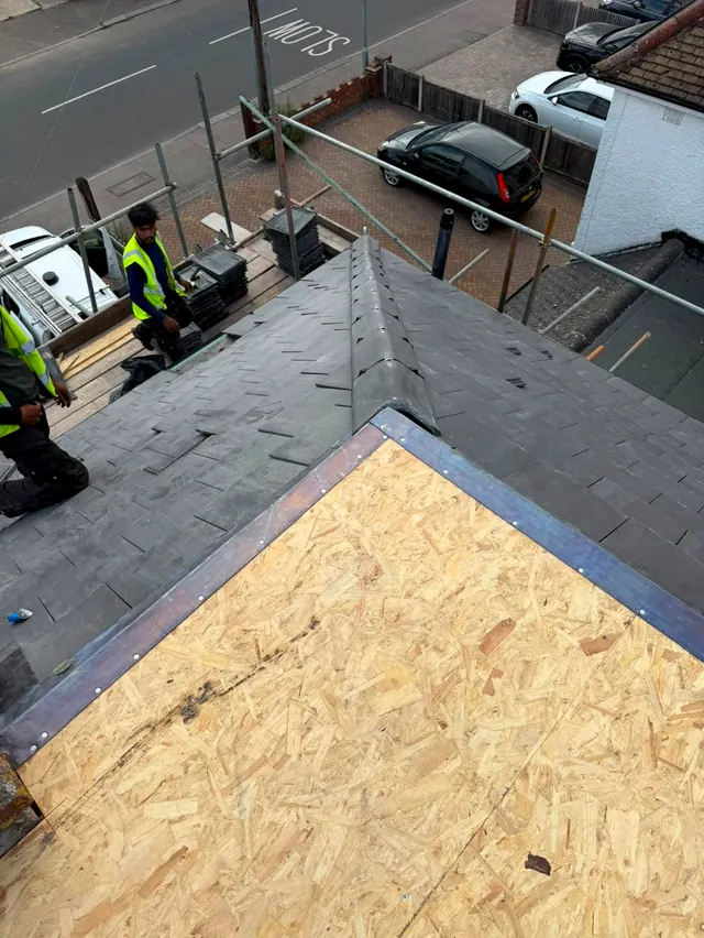 A new timber deck on a flat roof beside a freshly tiled pitched roof