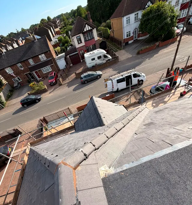 A new hip and ridge on a slate roof, seen from the scaffold