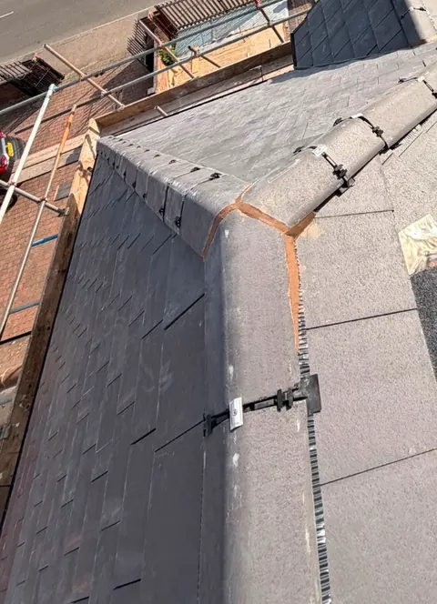 New slates and a lead-dressed hip on a slate roof